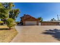 Exterior view of home, showcasing the two-car garage and large driveway at 6550 N 7Th St, Phoenix, AZ 85014