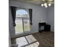 Bright bedroom with a large window, wood floors, ceiling fan, and ample natural light at 696 W Shawnee Dr, Chandler, AZ 85225