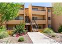Multi-level apartment building featuring landscaped grounds, inviting pathways, and convenient stair access for residents and guests alike at 8055 E Thomas Rd # C203, Scottsdale, AZ 85251