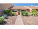 Charming single-story home with desert landscaping and a welcoming walkway at 8055 E Thomas Rd # D111, Scottsdale, AZ 85251