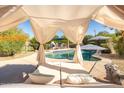 Relaxing poolside view with lounge seating under a draped canopy, perfect for outdoor relaxation at 9035 W Villa Chula --, Peoria, AZ 85383