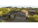 Aerial view of a suburban home and backyard featuring lush green trees and mountain views on a clear day at 9517 E Minton St, Mesa, AZ 85207