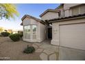 Front exterior view of a charming home with a desert landscape, walkway, and two-car garage at 9517 E Minton St, Mesa, AZ 85207