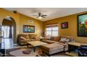 Comfortable living room featuring neutral tones, plush sofas, and a large patterned rug, perfect for relaxing at 10952 S Desert Lake Dr, Goodyear, AZ 85338