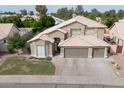 An aerial view of a lovely two-story home with manicured lawn, three-car garage and tile roof at 1132 E Sheffield Ave, Chandler, AZ 85225