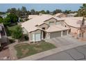 An aerial view of a well-kept two-story home with manicured lawn, three-car garage and landscaped yard at 1132 E Sheffield Ave, Chandler, AZ 85225