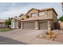Two-story home showcasing a spacious three-car garage, neutral color palette and well-kept landscaping at 1132 E Sheffield Ave, Chandler, AZ 85225