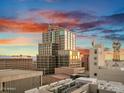 Expansive city view with striking sunset and modern high rise architecture in the background at 114 W Adams St # Ph, Phoenix, AZ 85003