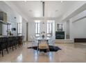 Spacious dining room with modern table, sleek chairs, and a minimalist fireplace in an open-concept design at 114 W Adams St # Ph, Phoenix, AZ 85003