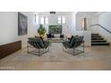 Stylish living room featuring chic seating, modern art, and a bright, airy atmosphere with ample natural light at 114 W Adams St # Ph, Phoenix, AZ 85003