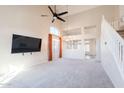 Spacious carpeted living room with tall ceilings, large windows, and staircase at 1227 E Sheena Dr, Phoenix, AZ 85022