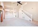 Spacious carpeted living room with tall ceilings and staircase at 1227 E Sheena Dr, Phoenix, AZ 85022