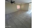 Bright living room with tiled floors and ceiling fan at 1352 S 221St Ln, Buckeye, AZ 85326