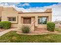 Welcoming desert home with an inviting front entrance and mature shrubbery enhancing its curb appeal at 14402 N 58Th Dr, Glendale, AZ 85306