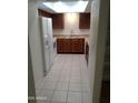 A well-lit kitchen boasts tile flooring, wood cabinets, and modern appliances at 14402 N 58Th Dr, Glendale, AZ 85306