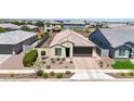An aerial view showcases this well-maintained home with a private driveway and desert landscaping at 14408 W Bloomfield Rd, Surprise, AZ 85379
