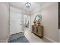 Welcoming foyer features neutral walls, tile flooring, and stylish decor at 14408 W Bloomfield Rd, Surprise, AZ 85379
