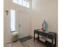 Bright foyer with neutral walls, a high ceiling and a decorative table at 14624 N 44Th St, Phoenix, AZ 85032