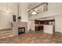 Spacious living area with soaring ceilings, fireplace and a staircase leading to the second floor loft at 1535 N Horne -- # 67, Mesa, AZ 85203