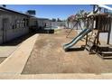 Spacious backyard featuring playset and potential for landscaping and outdoor activities at 1550 W Willow Ave, Phoenix, AZ 85029