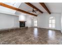 Spacious living room with wooden beams, tile floors, and fireplace, perfect for gatherings at 1550 W Willow Ave, Phoenix, AZ 85029