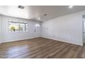 Bright, spacious living room featuring new flooring and a front-facing window at 1550 W Willow Ave, Phoenix, AZ 85029