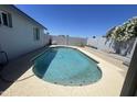 Backyard pool with clear water surrounded by a concrete patio and block fencing at 1550 W Willow Ave, Phoenix, AZ 85029