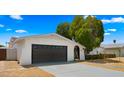 Charming single-story home with a well-manicured front yard and dark grey two-car garage at 1615 E Fremont Dr, Tempe, AZ 85282