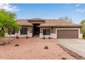 Inviting single-story home with a desert landscape, tiled roof, and a warm, neutral color palette at 18 E Paint Your Wagon Trl, Phoenix, AZ 85085