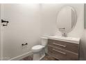 Stylish half-bath with modern vanity, sink, oval mirror and updated fixtures at 2019 E Campbell Ave # 110, Phoenix, AZ 85016