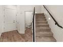Entryway with white trim, stairs and half-bath featuring wood laminate flooring at 2019 E Campbell Ave # 110, Phoenix, AZ 85016