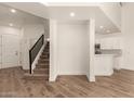 Open floor plan with living room, kitchen and stairs featuring wood laminate floors at 2019 E Campbell Ave # 110, Phoenix, AZ 85016