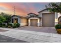 Charming single-story home showcasing a well-manicured lawn, neutral color palette, and a three-car garage at 21408 S 224Th Pl, Queen Creek, AZ 85142