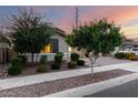 Landscaped front yard featuring mature trees, low shrubs, decorative rock, and a paved walkway leading to the home at 21408 S 224Th Pl, Queen Creek, AZ 85142
