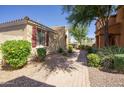 Landscaped side yard with a brick pathway and low-water plants, creating an inviting outdoor space at 3450 E Milky Way, Gilbert, AZ 85295