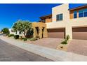 Contemporary two-story home featuring a well-maintained yard and a convenient two-car garage at 36145 N Desert Tea Dr, Queen Creek, AZ 85140