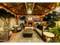 Cozy backyard patio with fireplace, seating, and chandelier lighting at 4833 N 38Th St, Phoenix, AZ 85018