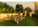 Landscaped backyard featuring a picnic table beneath cafe-style lighting at 4833 N 38Th St, Phoenix, AZ 85018