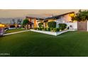 Home exterior showcasing lush green lawn, manicured hedges, and beautiful landscaping with a gazebo at 4833 N 38Th St, Phoenix, AZ 85018