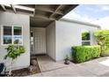 Welcoming front entrance with decorative door, manicured bushes, and window at 609 E Royal Palm S Sq, Phoenix, AZ 85020