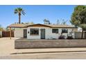 Charming single-story home featuring a neutral color scheme, well-manicured landscape and a welcoming front entrance at 653 W Inglewood St, Mesa, AZ 85201