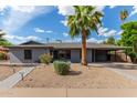 Charming single-story home with a desert landscape, covered parking, and a grey exterior at 6810 E Almeria Rd, Scottsdale, AZ 85257