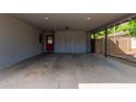 Spacious garage with built-in cabinets and a red door leading to the main house at 6810 E Almeria Rd, Scottsdale, AZ 85257