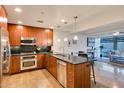 Stylish kitchen with wooden cabinets, stainless appliances, and granite countertops at 7161 E Rancho Vista Dr # 1013, Scottsdale, AZ 85251