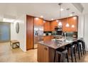 Modern kitchen with stainless steel appliances, sleek countertops, and breakfast bar at 7161 E Rancho Vista Dr # 1013, Scottsdale, AZ 85251