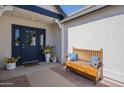Inviting entryway with a decorative bench and a beautifully adorned front door, creating a warm welcome at 717 E Temple St, Chandler, AZ 85225