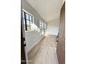 Bright living room with wood floors, fresh paint, and large windows at 8625 E Belleview Pl # 1070, Scottsdale, AZ 85257