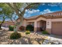 Attractive single-story home featuring low-maintenance desert landscaping and a welcoming entrance at 8765 W Custer Ln, Peoria, AZ 85381