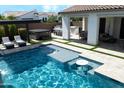 Beautiful pool with built-in bar, a hot tub, and covered seating area, perfect for outdoor entertaining at 10520 E Thorite Cir, Mesa, AZ 85212