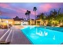 Sparkling pool with outdoor seating and lush landscaping, creating a private oasis at 10658 E Cinnabar Ave, Scottsdale, AZ 85258